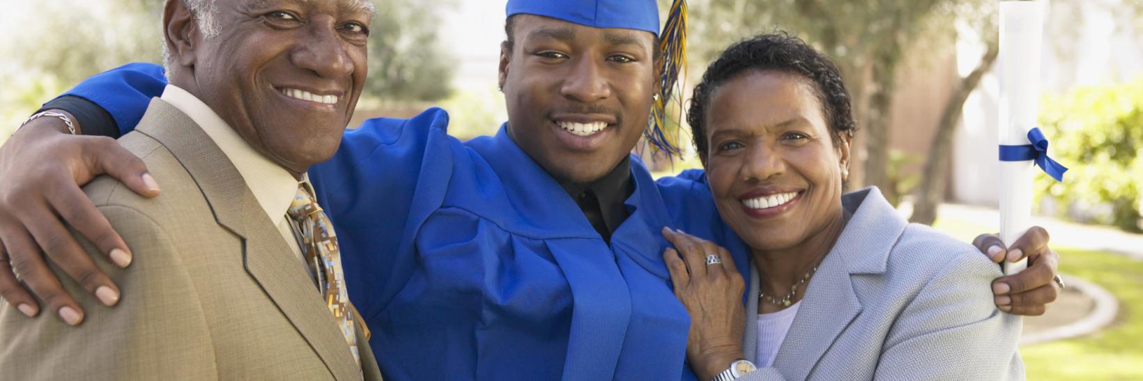 young man and his parents at graduation