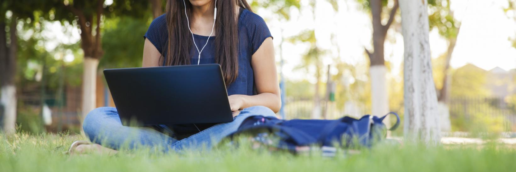 girl using a laptop outside