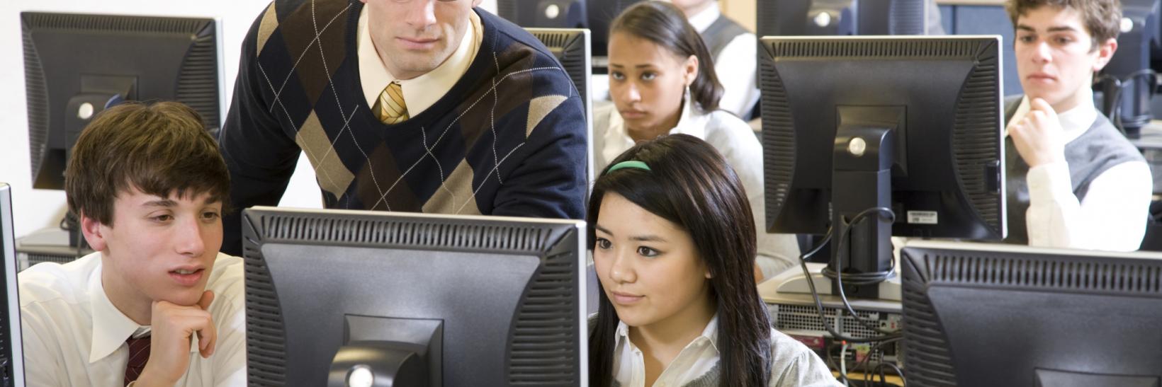 teacher and students in a computer lab