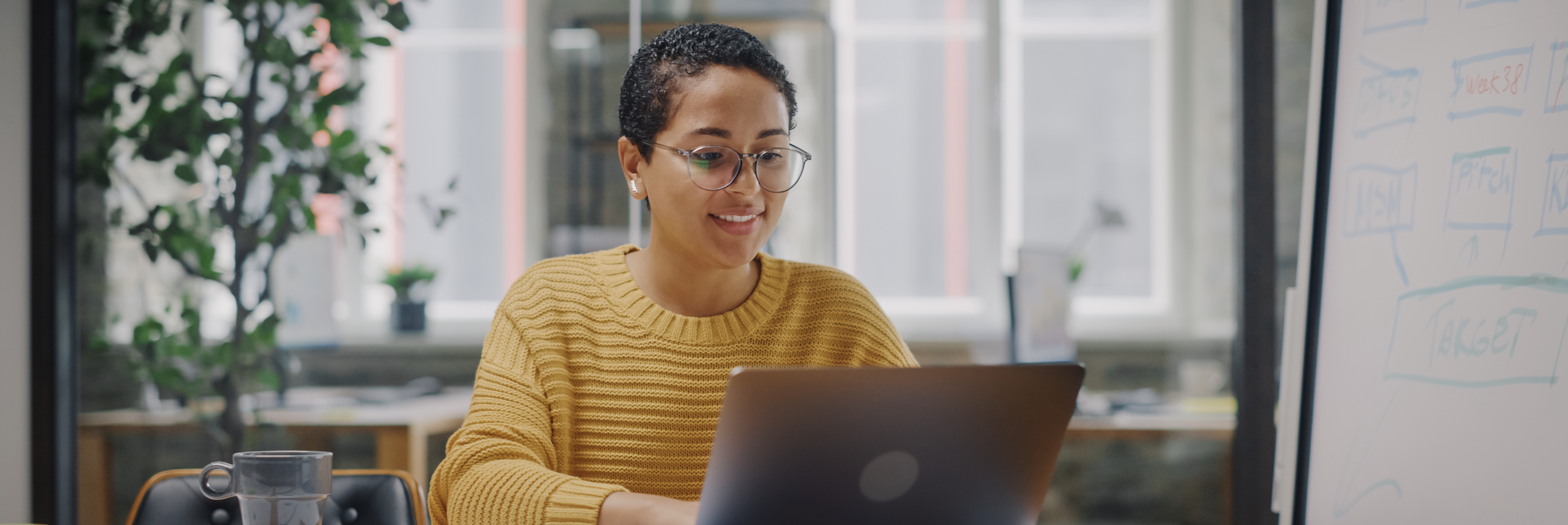 Woman types on laptop 