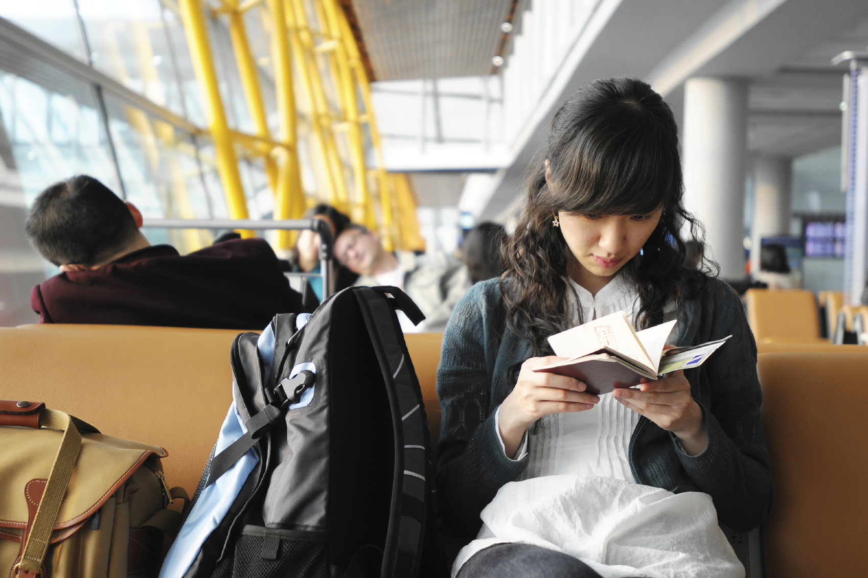 Person reading next to backpack