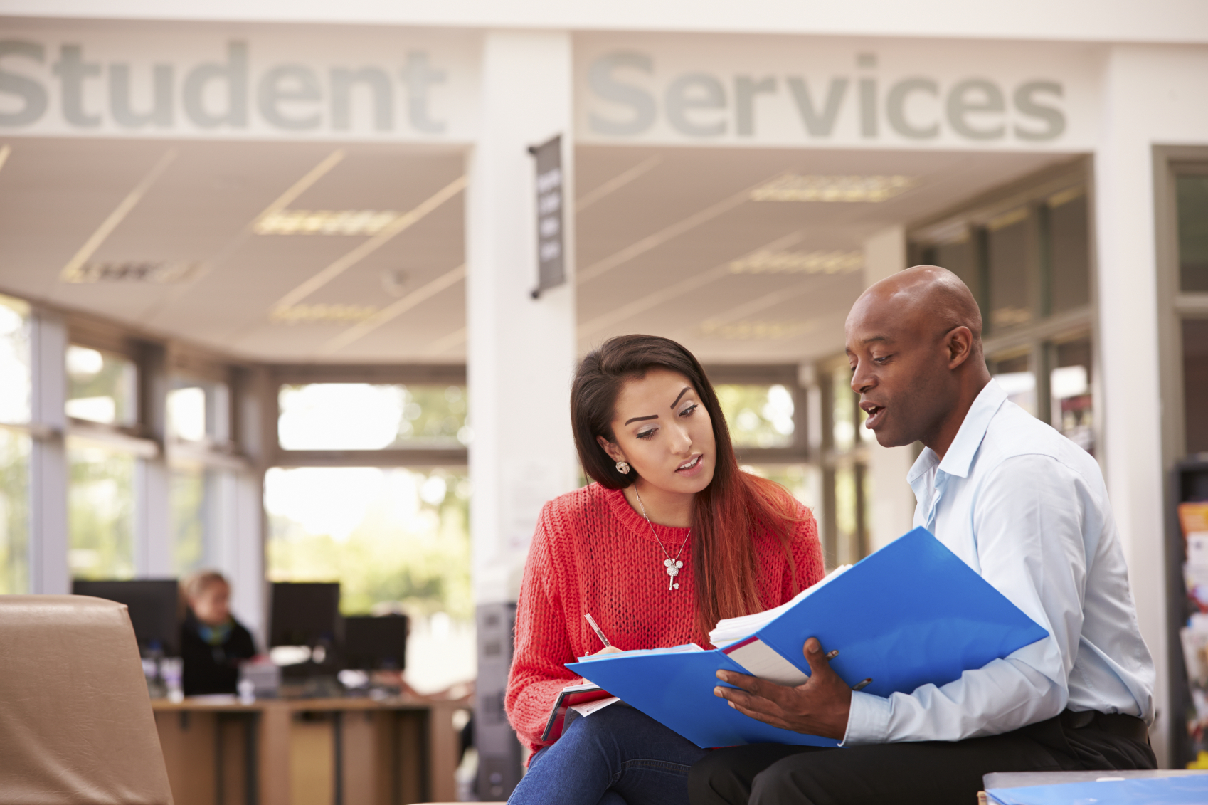 Two individuals reviewing paperwork