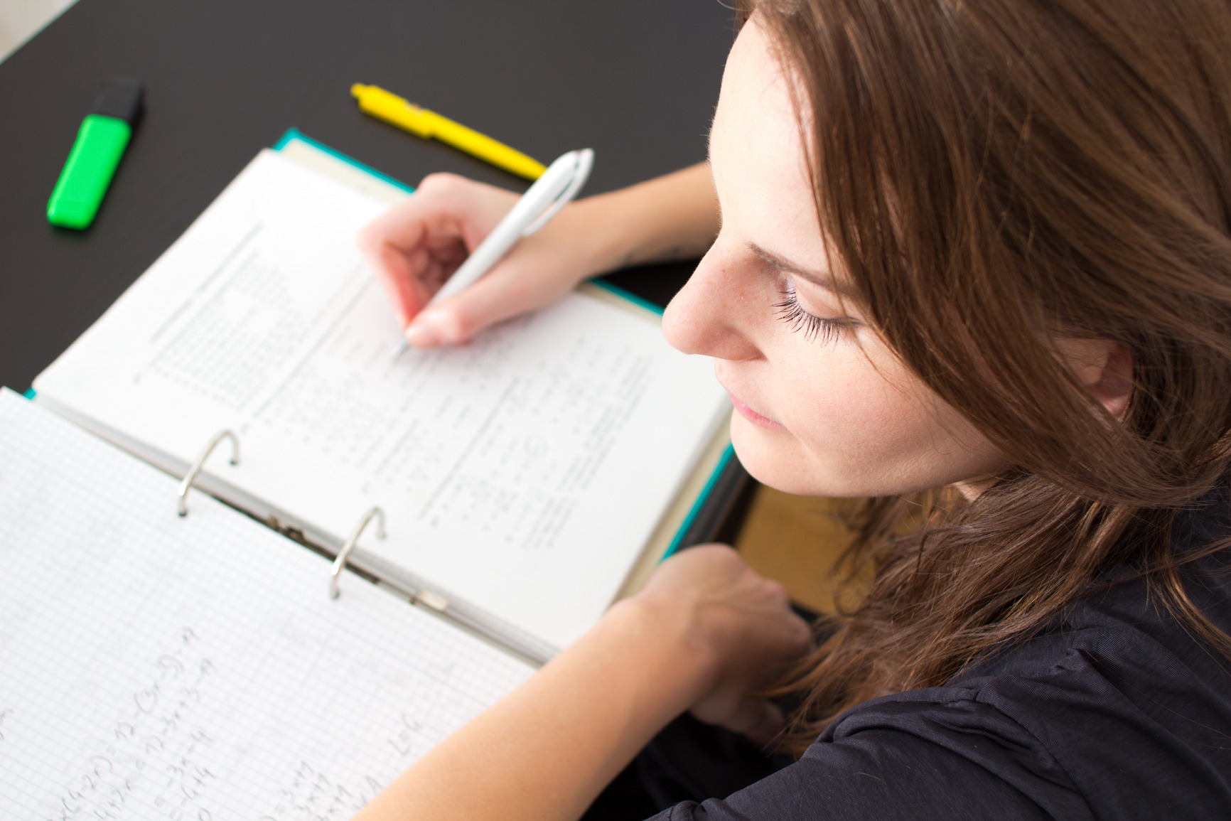 Some studies. A girl writing on a Pen students.