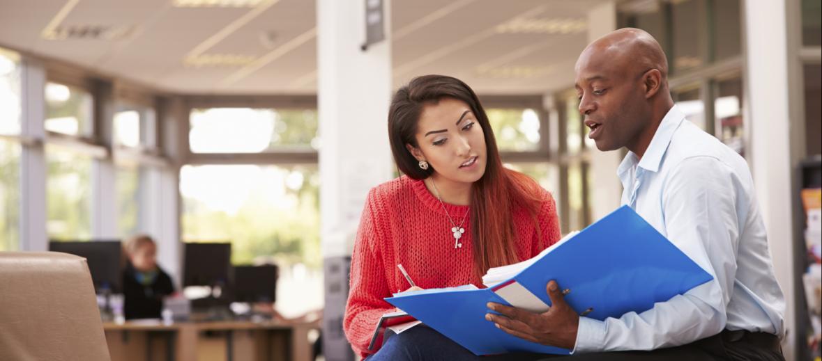 Two individuals reviewing paperwork