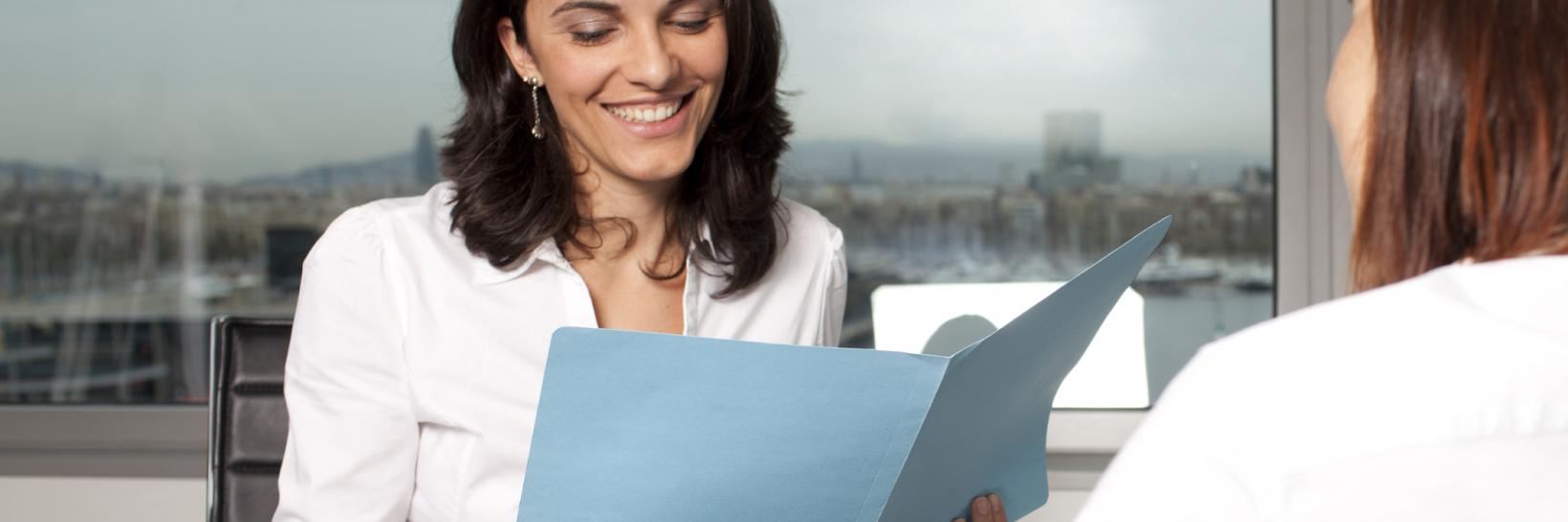 woman reads from a folder