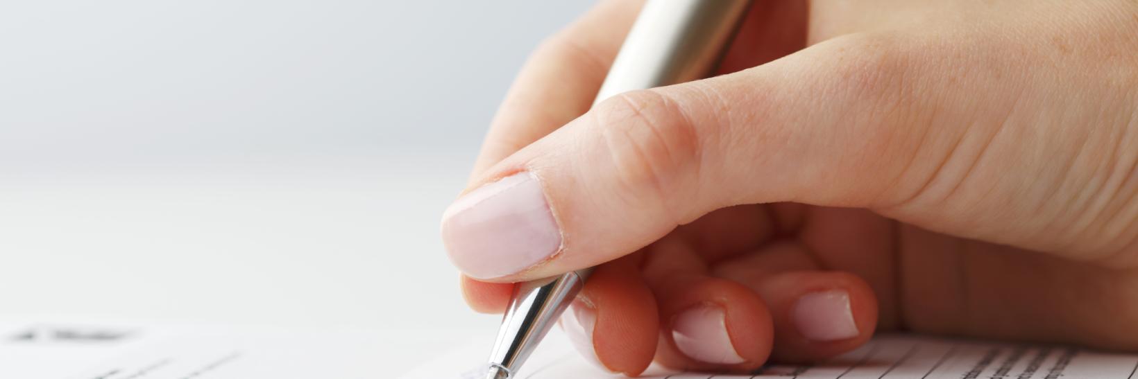 hand signing a document 