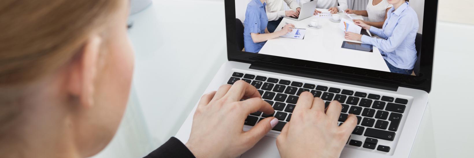 woman watching a webinar on her computer