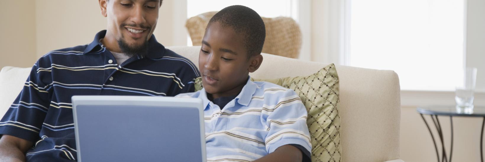 man and his son on a laptop