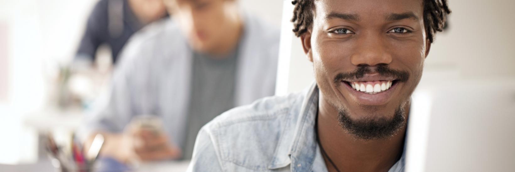 Man smiling at laptop