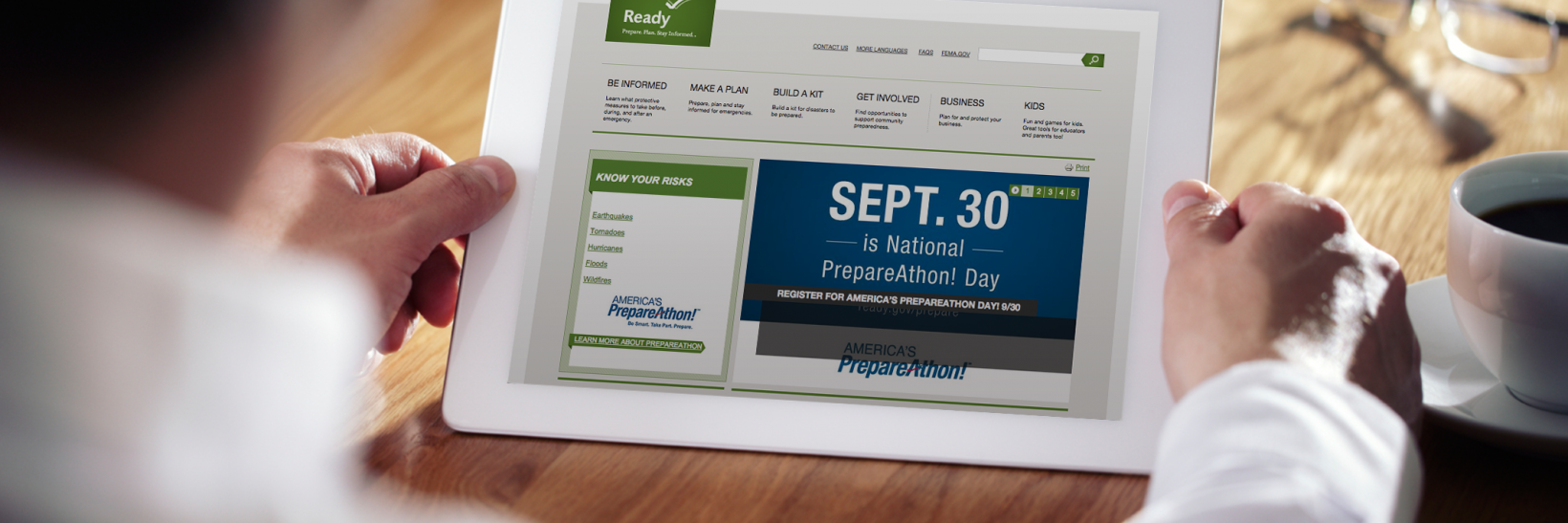 Man holding tablet with Ready.gov's homepage loaded, promoting September 30.