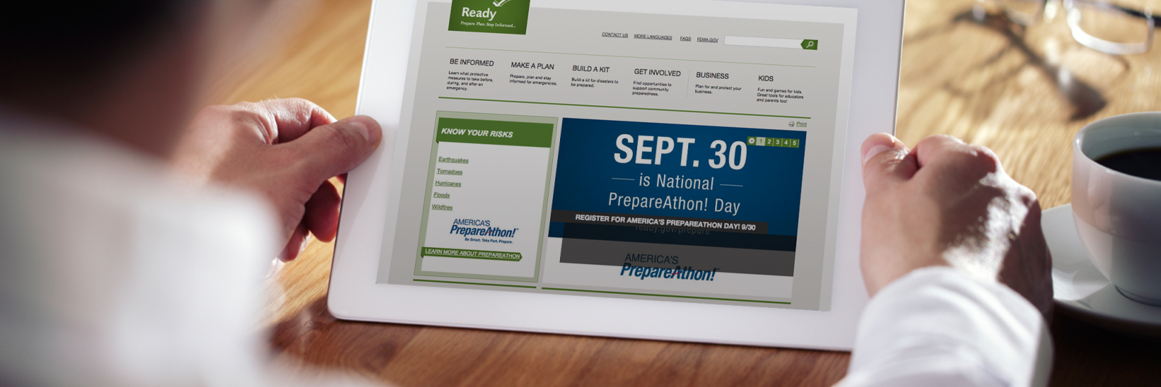 Man holding tablet with Ready.gov's homepage loaded, promoting September 30. 