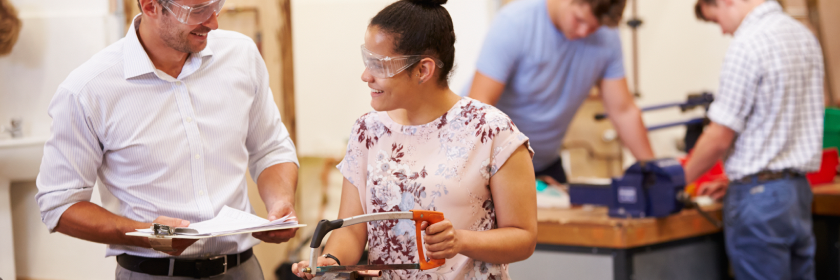 Student and teacher working in a wood shop class. 