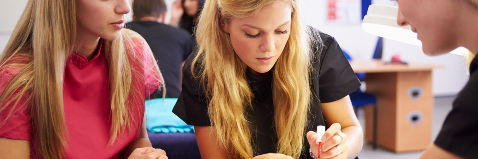 Teacher training a nail technician.  