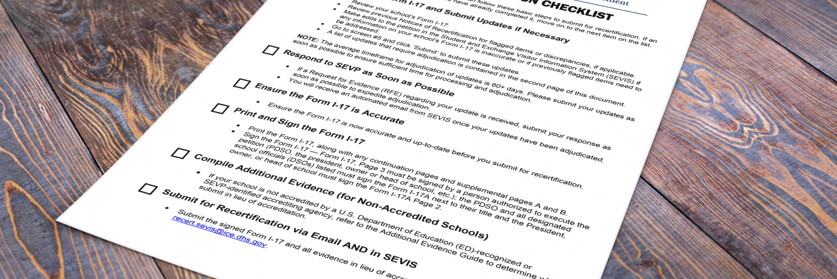 SEVP Recertification Checklist on a wooden table.