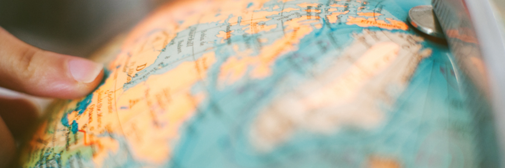 Close up of someone's hands on a globe