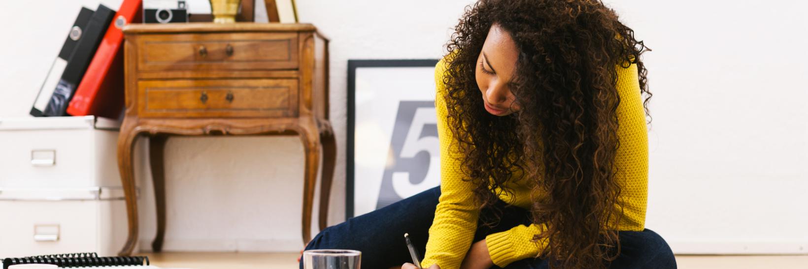 Young university woman studying at home.