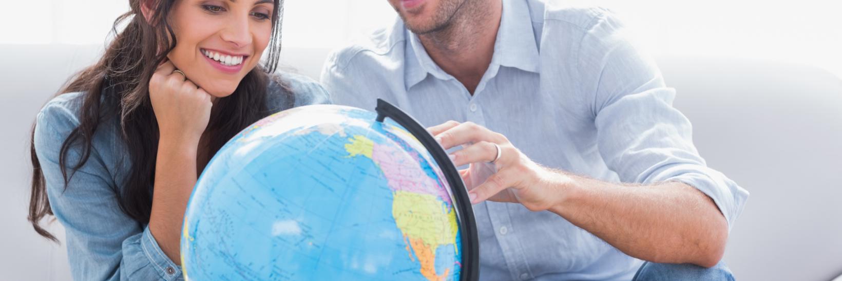 a couple looking at a globe