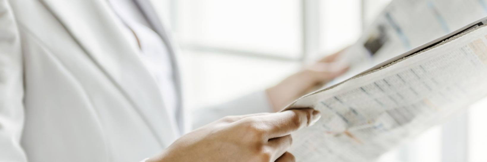 person reading a newletter