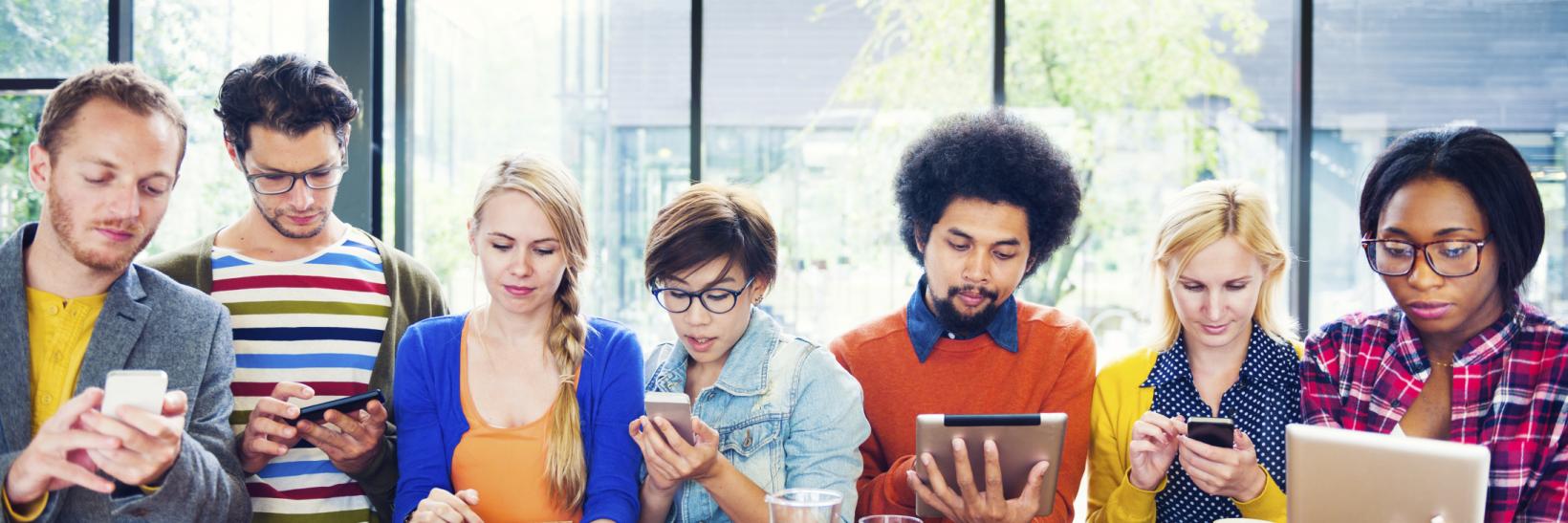 group of young adults on mobile devices