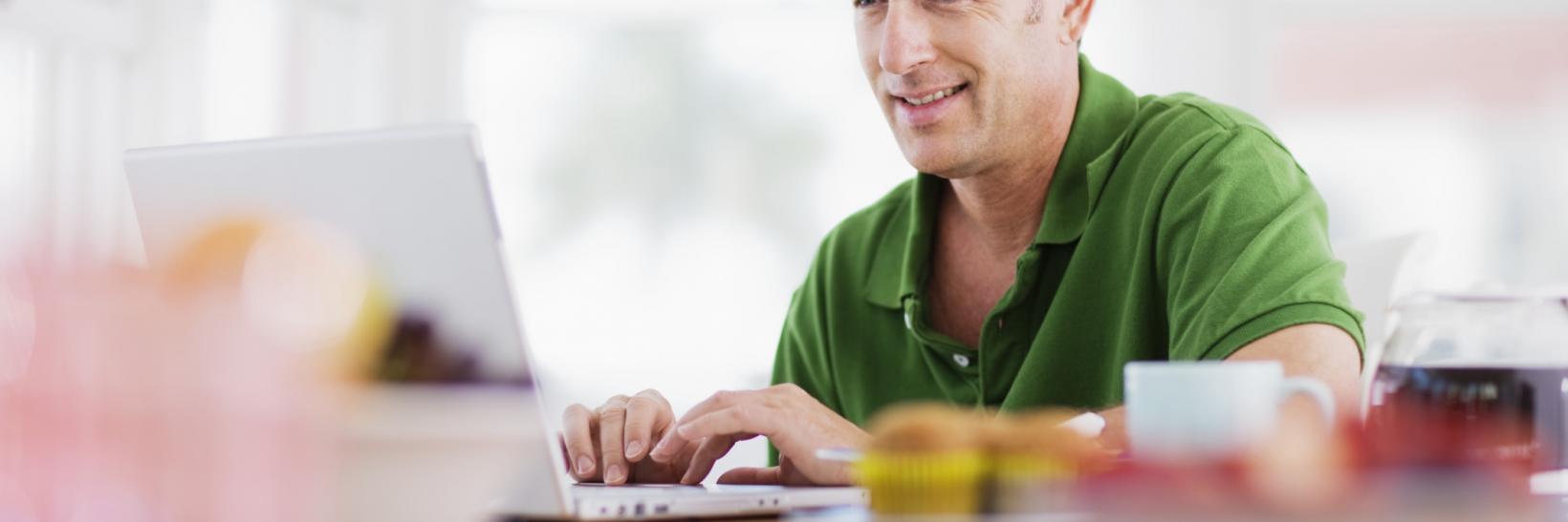 man sitting at a laptop