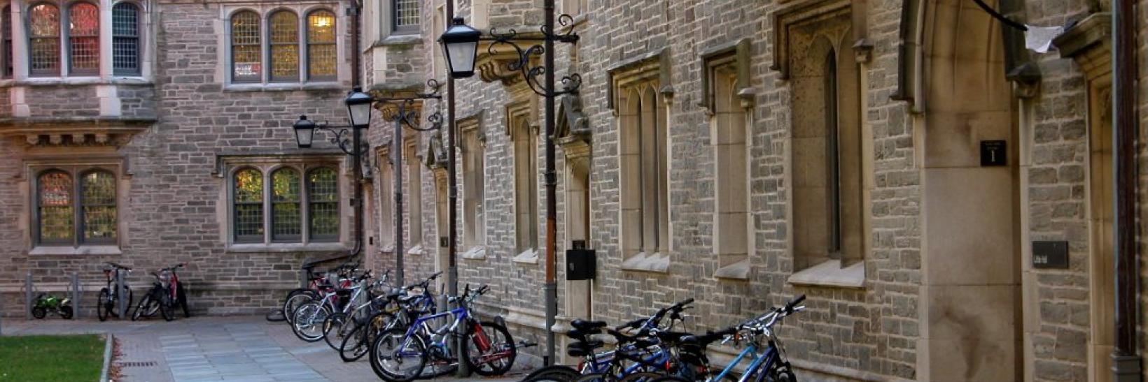 Student bikes outside campus building. 