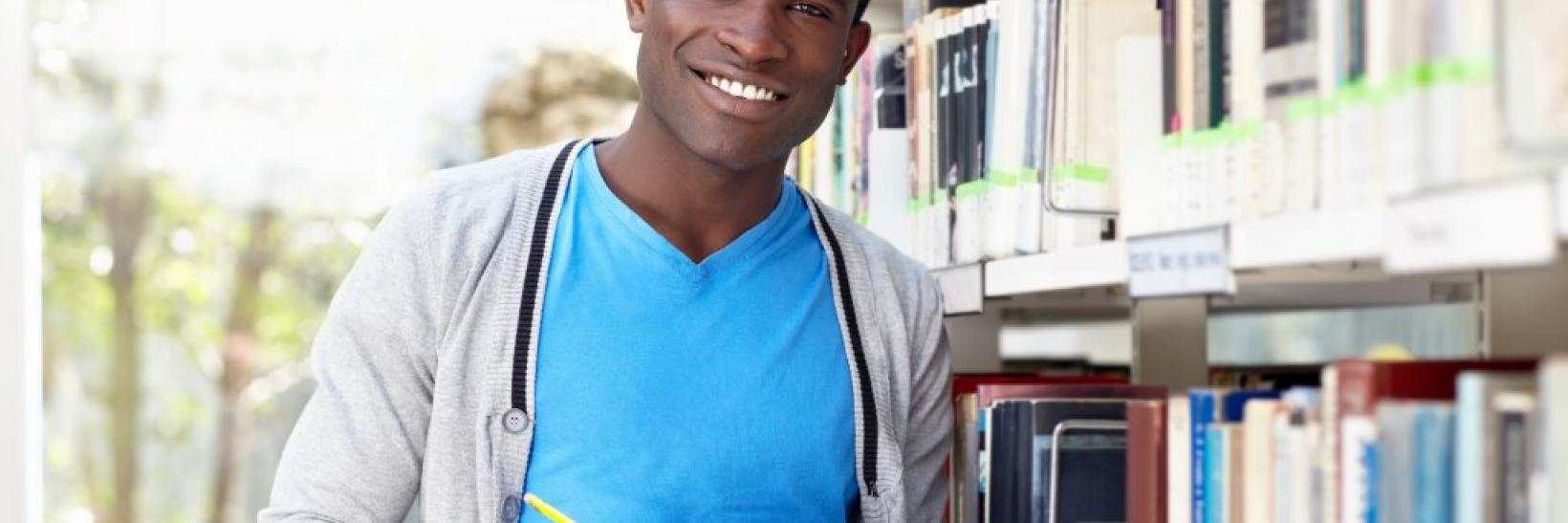 Student with books to help him choose a school. 