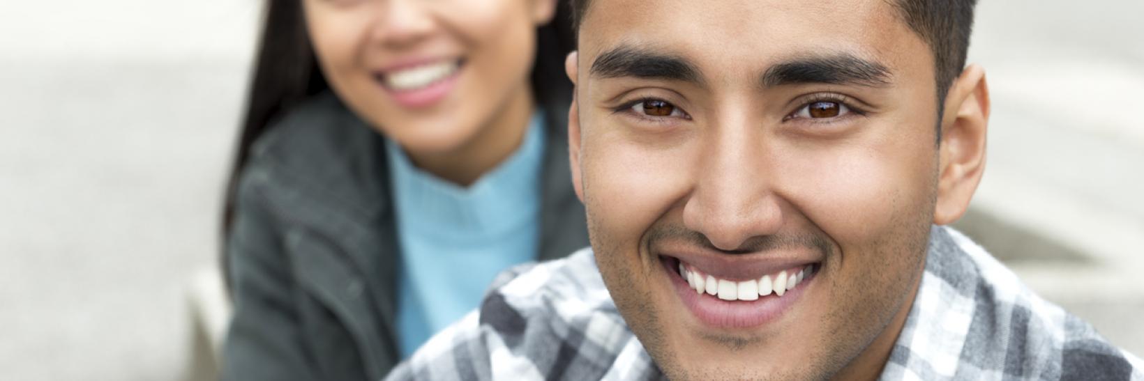 A man and woman smiling. 