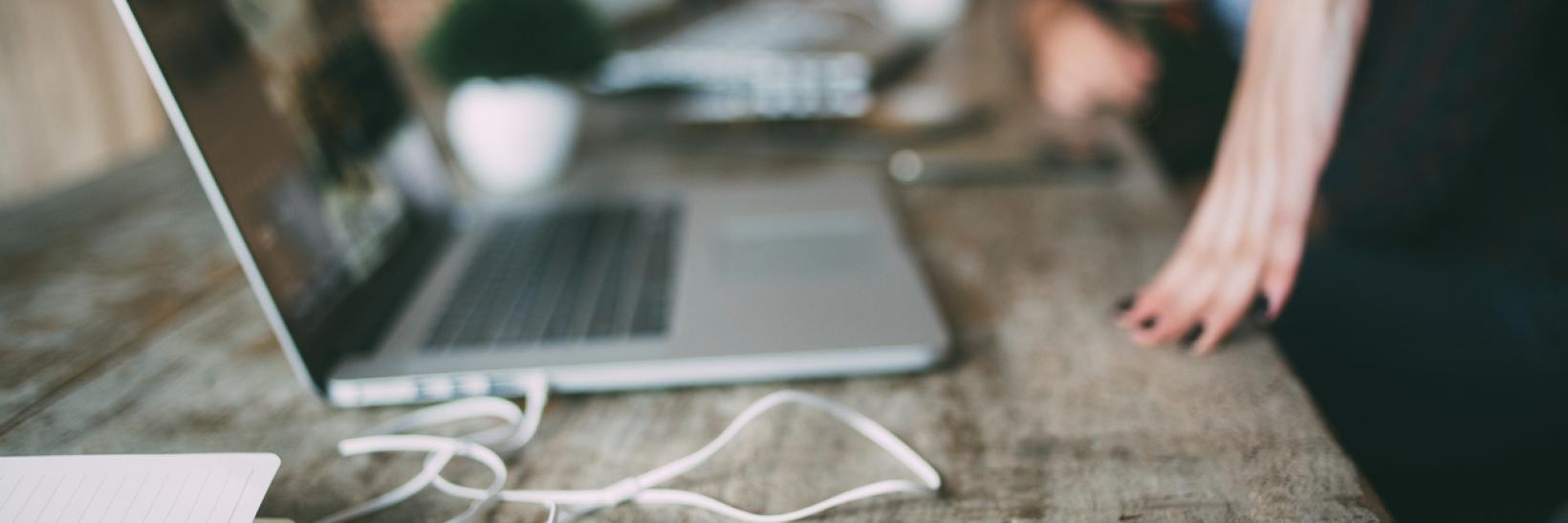 Laptops with headphones sitting on the table.