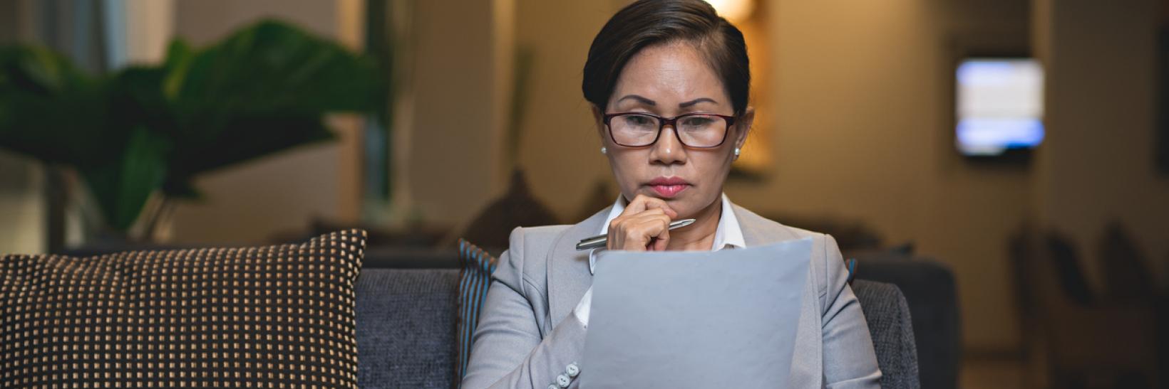 A woman reading a document.