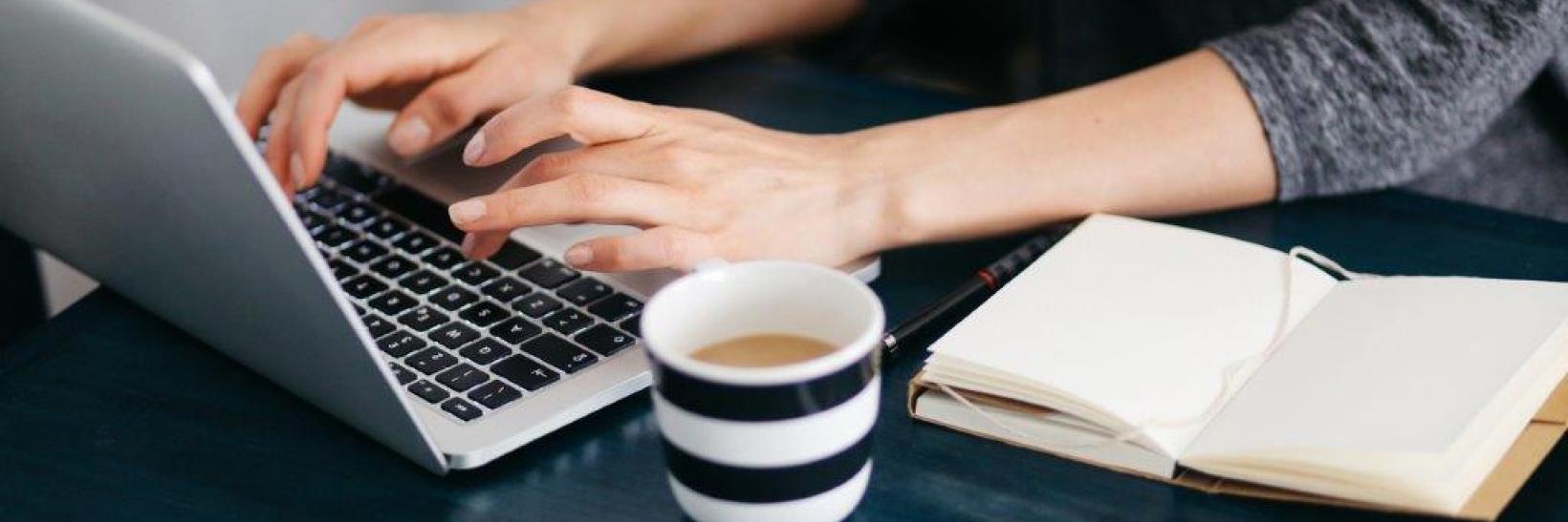 A person typing on a laptop computer.