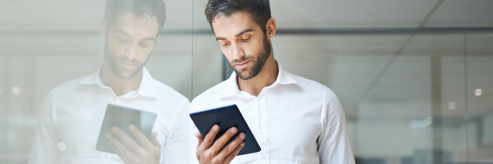 A man reading a tablet.
