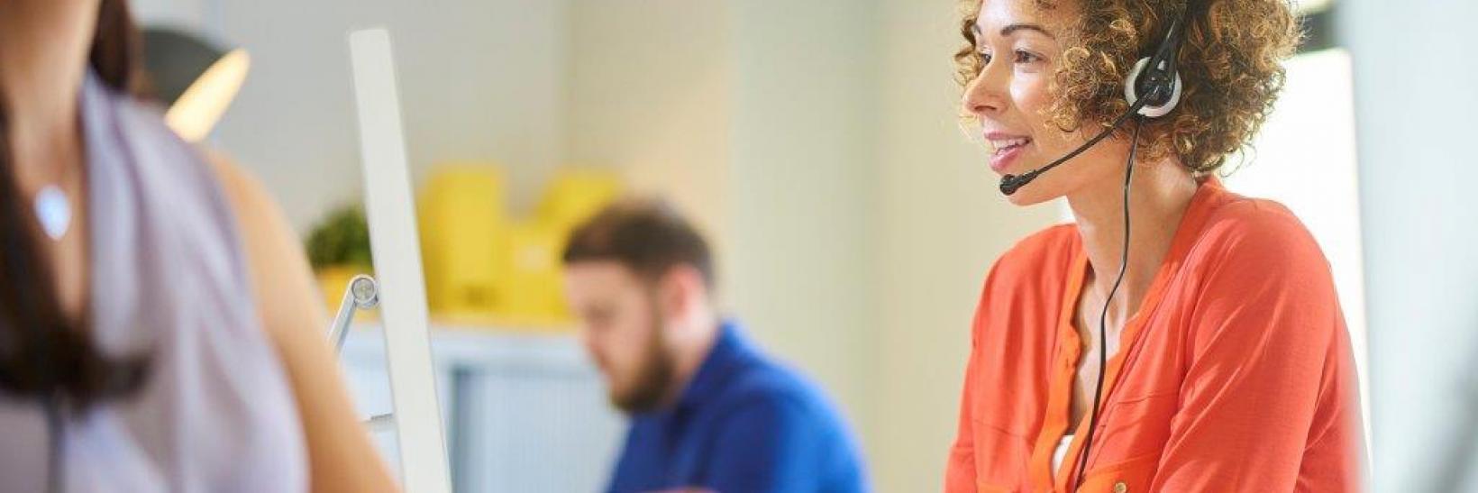 A woman wearing a telephone headset. 