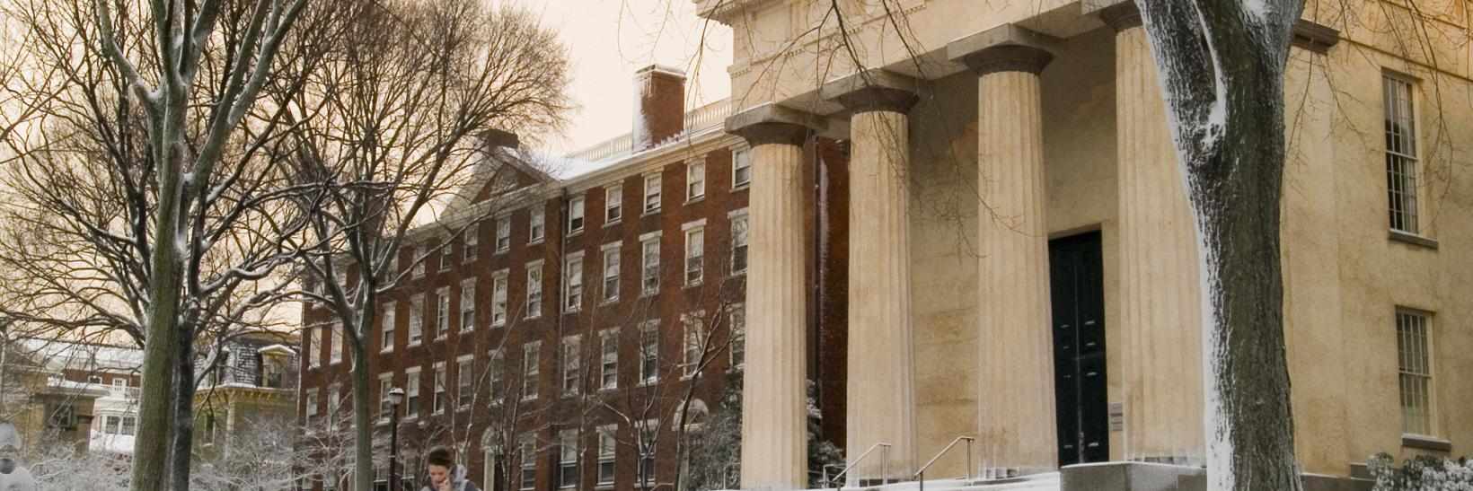 Student walking on a snowy college campus 