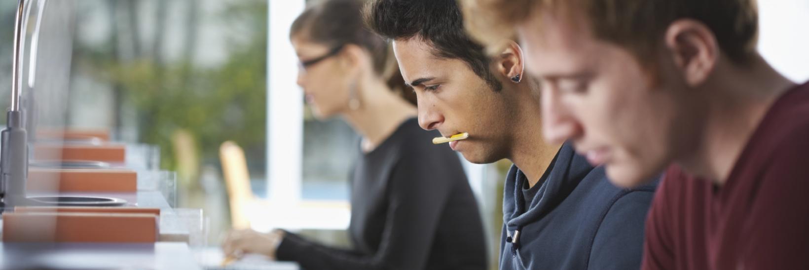 three students in a library