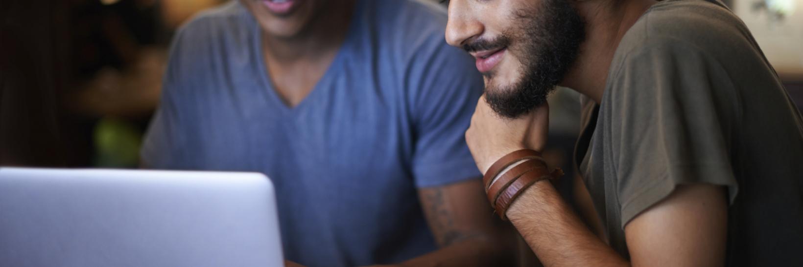 two young men on a laptop