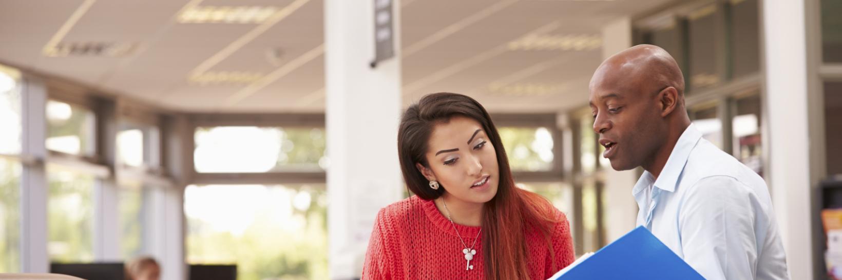 College student having a meeting with a student adviser 