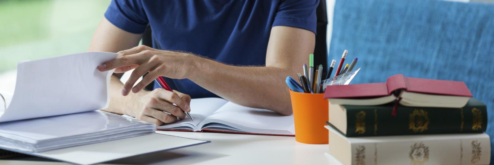 A male student studying at a desk