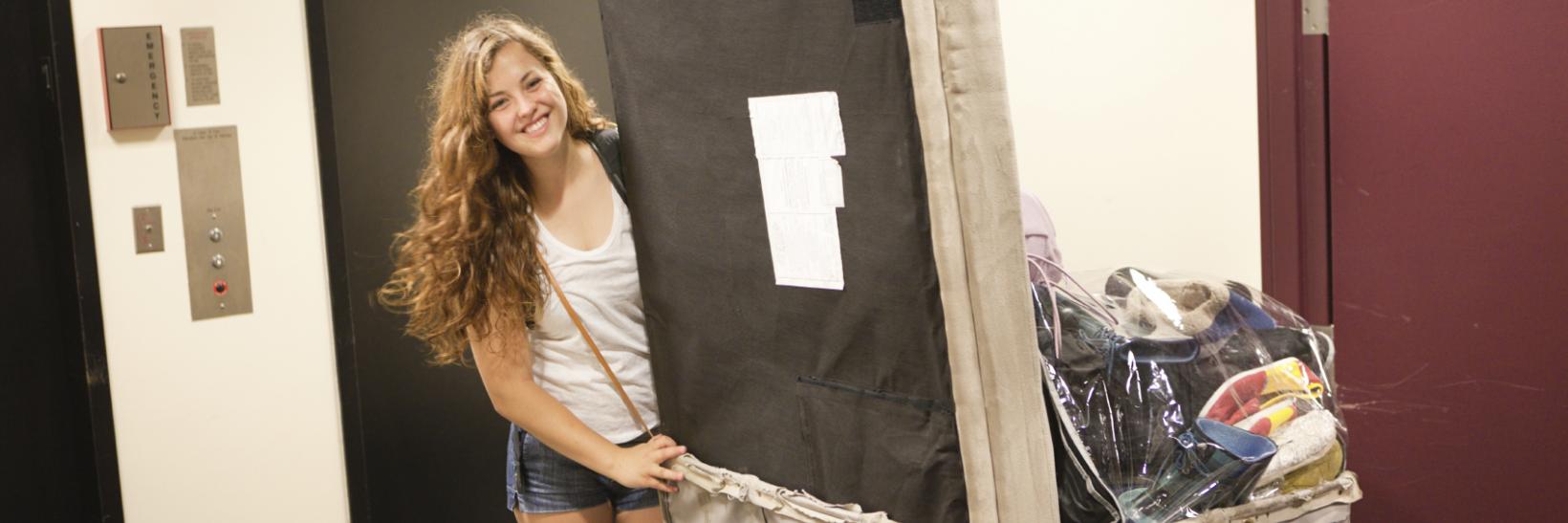 young woman student moving into a dorm room. 