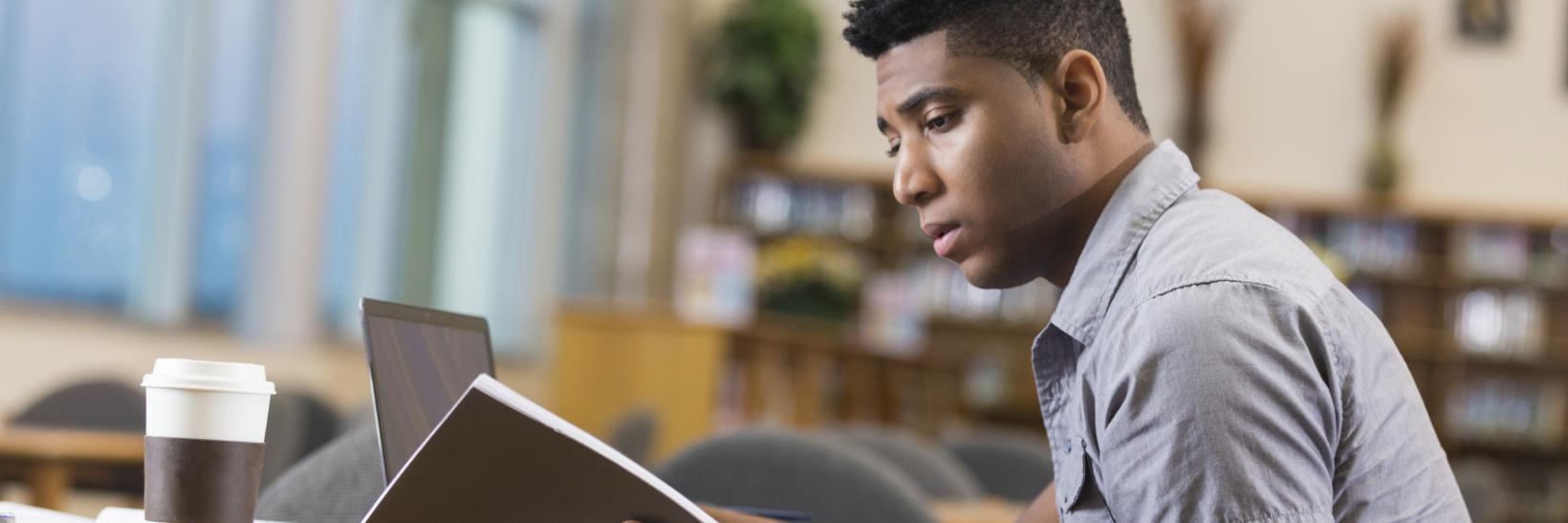 young man studying in the library.