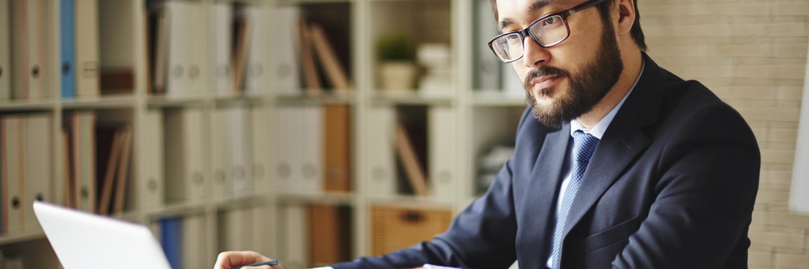 A man using a laptop computer. A man using a laptop computer.