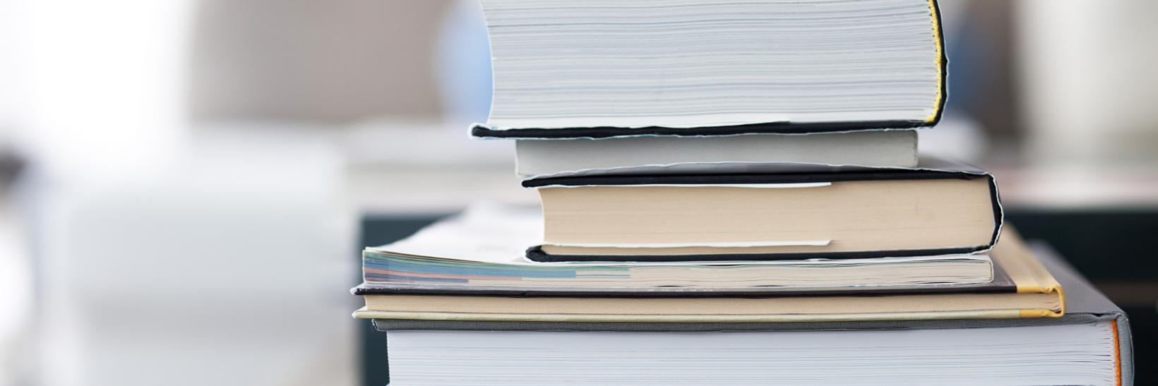 A stack of books on a table.