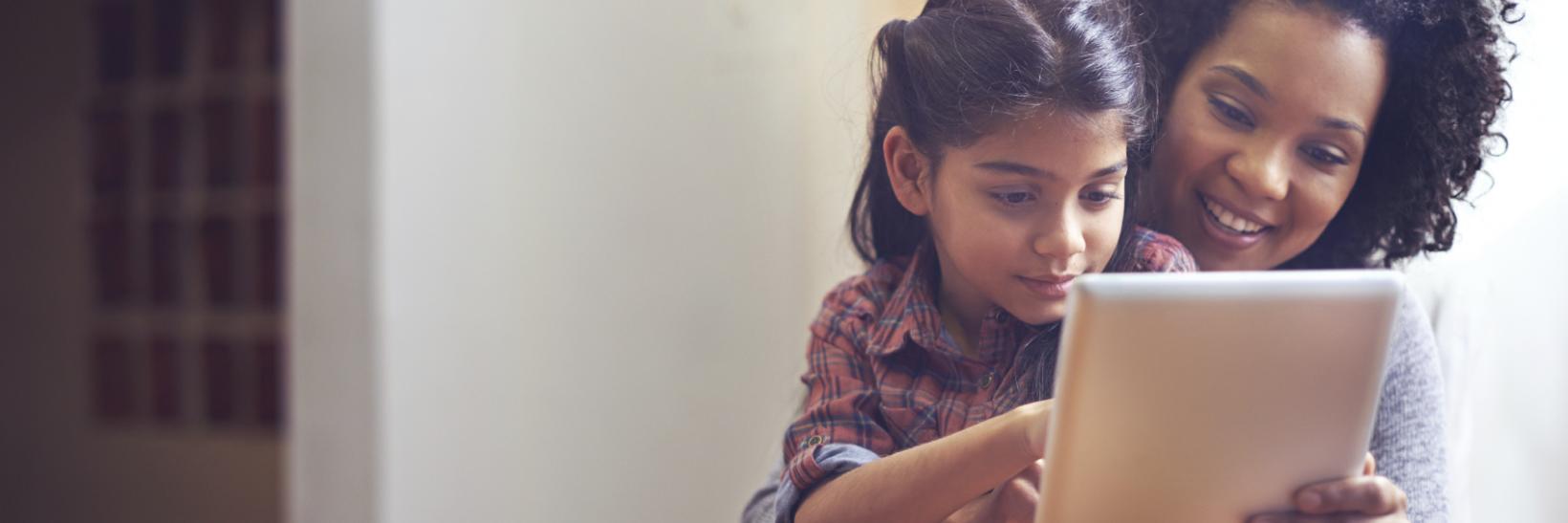 Mother and daughter using a tablet together. 