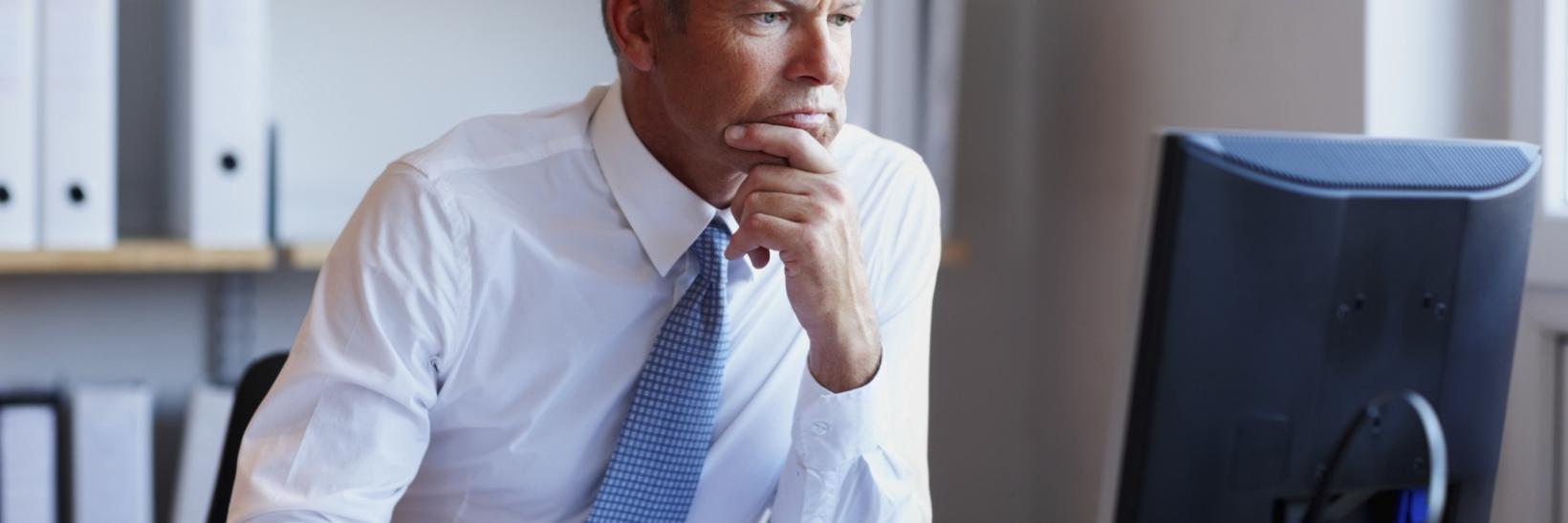 A man looking at his computer. 