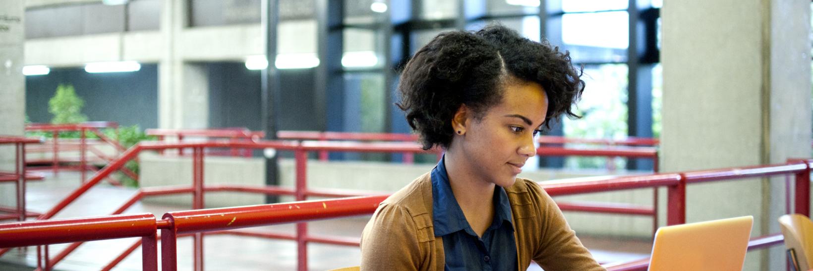 A female student using a laptop computer.