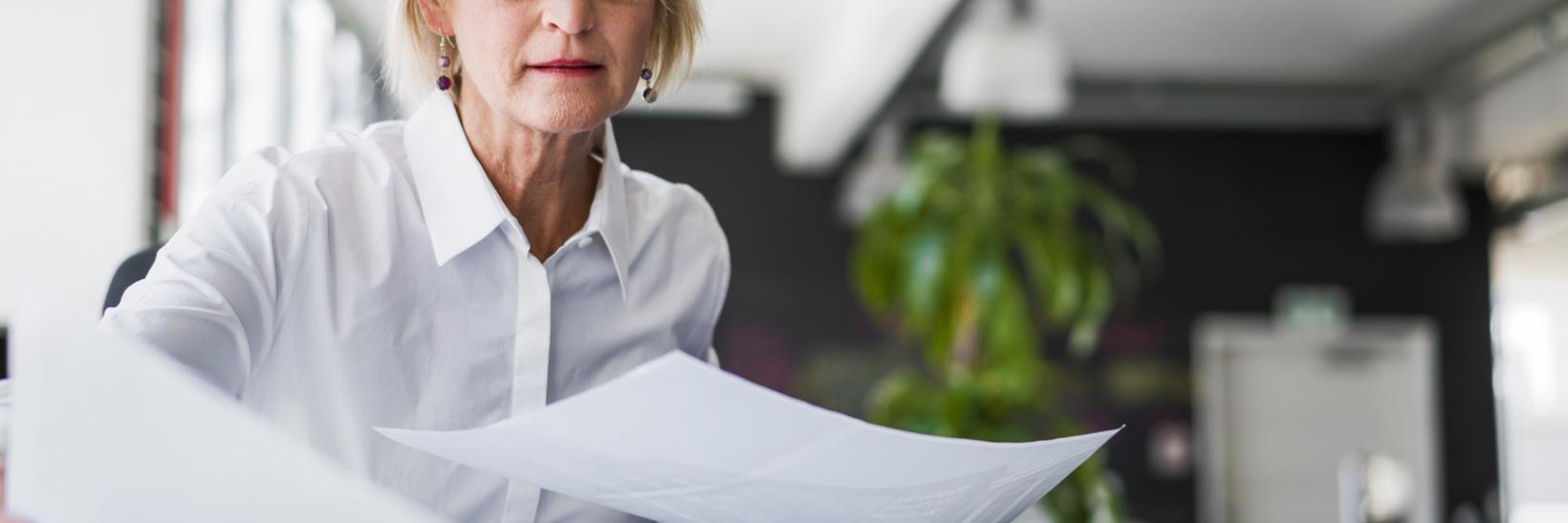 A woman examining documents.