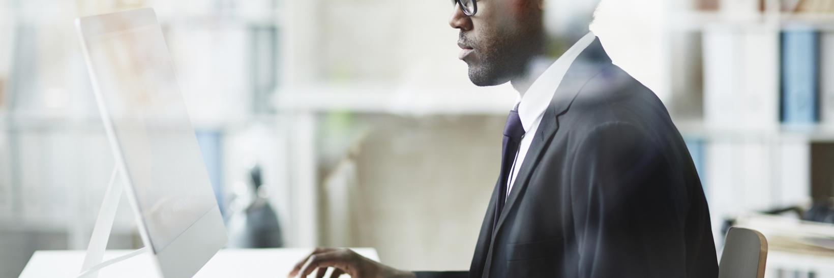 A man using a desktop computer.