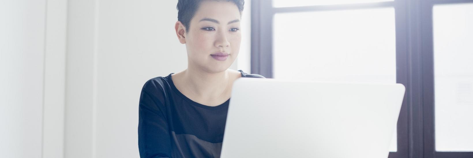 A woman working on her laptop computer.