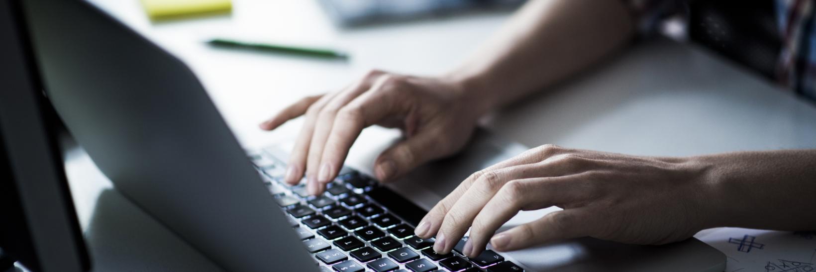 A person typing on a computer.