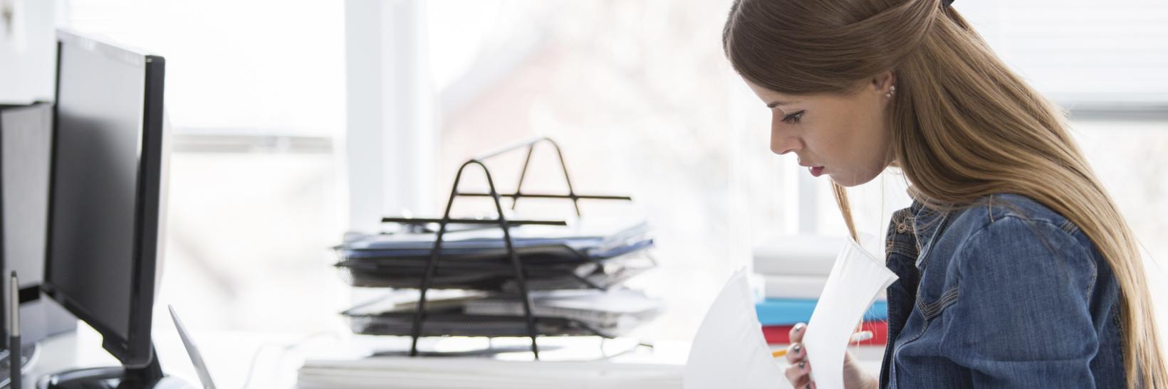 A woman looking through papers.