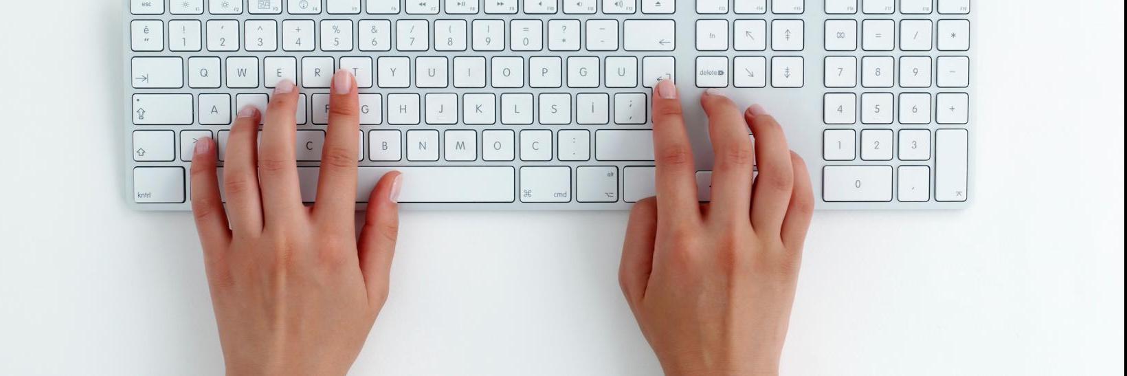 hands typing on a keyboard